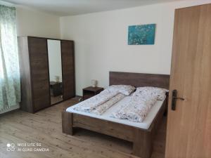 a bedroom with a bed and a wooden door at Samostatný rodinný dom in Veľký Meder