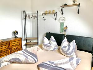 a bedroom with a bed with pillows on it at Eigenes Apartment im Herzen der Stadt mit Balkon und WLAN in Cottbus