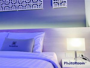 a bedroom with a white bed and a lamp at Peranakan Boutique Hotel - SHA Plus in Phuket +22 photos