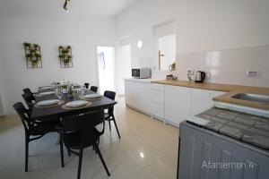 A kitchen or kitchenette at YalaRent Afarsemon Apartments with pool - For Families & Couples