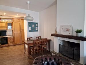 a living room with a dining room table and a fireplace at RESIDENZA DUOMO in Orvieto