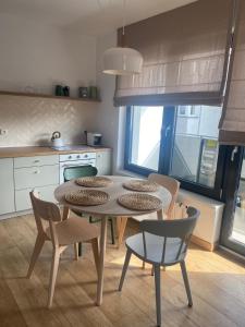 a kitchen with a table and chairs in a kitchen at Nice to sleep You in Toruń