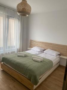 a bedroom with a large bed with two pillows at Nice to sleep You in Toruń