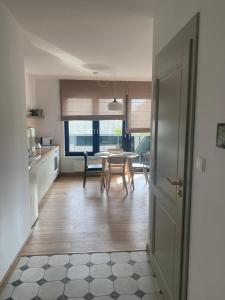 a kitchen and dining room with a table and chairs at Nice to sleep You in Toruń