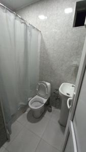 a bathroom with a toilet and a sink at Apartment in Gagarini in Tbilisi City