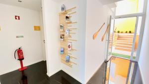 a hallway with a wall of magnets on the wall at Casa Amarela Guesthouse in Albufeira