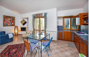 eine Küche und ein Wohnzimmer mit einem Glastisch und Stühlen in der Unterkunft Beautiful Home In Sabaudia With Jacuzzi in Sabaudia