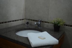 a bathroom sink with a white towel on it at Casa Patagonica in Puerto Madryn