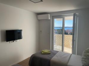 a bedroom with a bed and a flat screen tv at APP Robi in Novigrad Istria