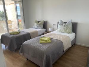 a bedroom with two beds with towels on them at APP Robi in Novigrad Istria
