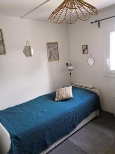 ラ・グランド・モットにあるAppartement du golfのベッドルーム1室(青い毛布付きのベッド1台付)