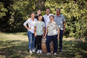 a group of people standing next to a barrel at Winzerhof Supperer in Rossatz