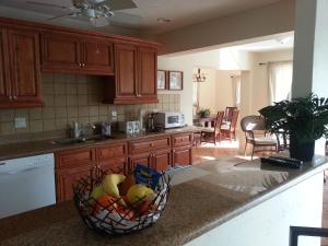 a kitchen with a basket of fruit on a counter at Villa Angel's Haven in Cape Coral