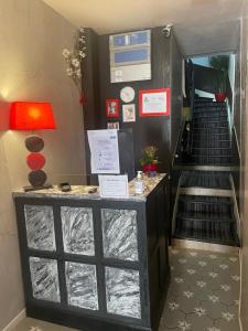 a room with a staircase with a counter and a stair case at Hotel Au Chapon Fin in Poitiers