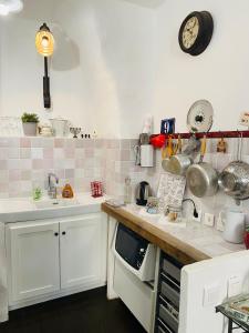 a kitchen with white cabinets and a counter with a sink at Le petit carnot in Apt