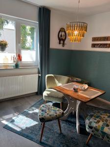 a living room with a table and a chair at Apartment Siegfried in Bayreuth