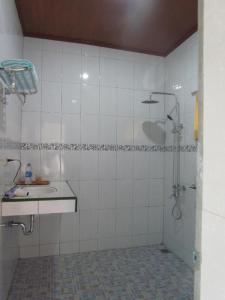 a bathroom with a shower and a sink at Lekjon Cottage in Tuk Tuk