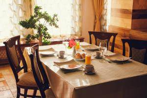 a table with food and drinks on top of it at Denisa Boutique in Poiana Brasov
