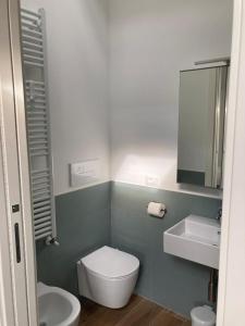 y baño con aseo, lavabo y espejo. en BiancoGelso b&b Vegan en Gardone Riviera