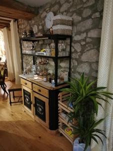 a room with a counter and a stone wall at La Petite Chapelle in Font-Romeu