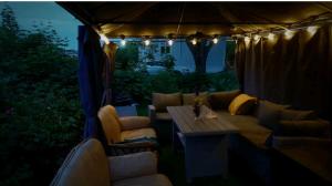 a living room with a couch and a table in a tent at Nahlboms in Sandefjord +2 photos