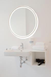 a bathroom with a white sink and a mirror at Quartier 99 in Innsbruck