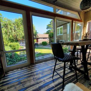 a screened porch with a table and chairs and large windows at Haus Daheim in Braunlage