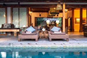 a resort with a swimming pool and a villa at Villa Pulau Cinta Boutique Suites in Gili Meno