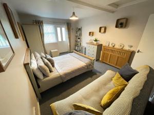 a bedroom with a bed and a couch at Westend Holiday Let 2 Brecon in Brecon