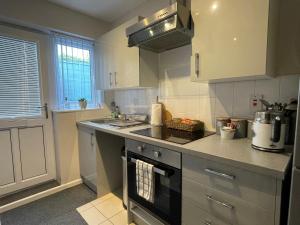 a kitchen with a sink and a stove top oven at Westend Holiday Let 2 Brecon in Brecon +5 photos