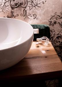 a white bowl on top of a wooden table at Agriturismo Maria Vittoria in Custoza