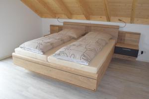 a bed with a wooden frame in a room at Sauers Schwarzwaldglück in Appenweier