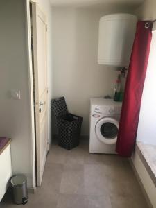 a laundry room with a washing machine and a washer at Petite maison de campagne in Recey-sur-Ource +2 photos
