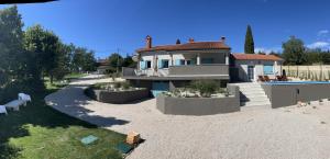 a house with a swimming pool in front of it at Casa Cavi Istria in Oprtalj