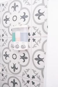 a bathroom with a toaster on a gray and white tiles at Migue´s Tiny Miami Alcove in Miami