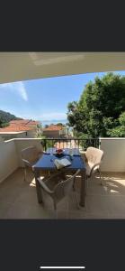 a table and chairs on a balcony with a view at Apartment Luna in Drvenik