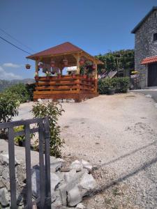 a wooden gazebo sitting on top of a hill at Holiday Home Pavle in Rijeka Crnojevića