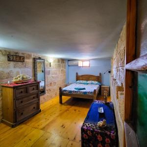 a bedroom with a bed and a dresser in a room at 1500 Little Pink House in Kalkara Creek in Kalkara