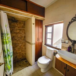 a bathroom with a toilet and a sink at 1500 Little Pink House in Kalkara Creek in Kalkara