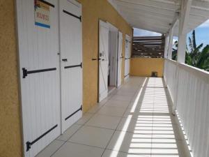 a hallway of a building with white doors at Villa Kajou in Sainte-Anne