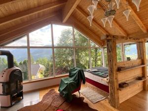 a bedroom with a bed in a room with windows at Atelier mit Bergblick 