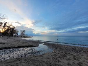 a beach with the ocean and a cloudy sky at "COZY LOFT", TERRACE, PARKING and SWIMMING POOL in Málaga