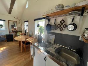 a kitchen with a sink and a counter top at Söndre Gårds Haväng in Glommen