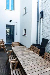 a wooden table and chairs on a patio at Edelweis in Blankenberge