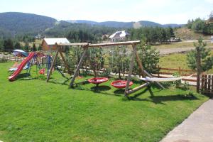 a group of playground equipment in a field at Vila Zlatibor Tornik in Zlatibor