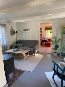 a living room with a couch and a table at Kræmmervikveien 33 in Ballstad +20 photos