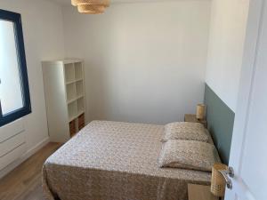 a small bedroom with a bed and a window at Maison avec vue sur le massif de l Étoile in Marseille