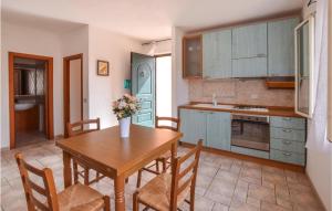 a kitchen and dining room with a table and chairs at Awesome Apartment In La Ciaccia With 1 Bedrooms in Codaruina