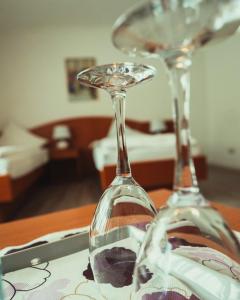 two wine glasses sitting on top of a table at Schlosspark-Hotel Hof von Oldenburg in Rastede