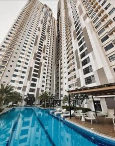 two tall buildings with a swimming pool in front of them at Horizon 101 A2 Shortwalk Robinson Mall Mango Square Bar in Cebu City
